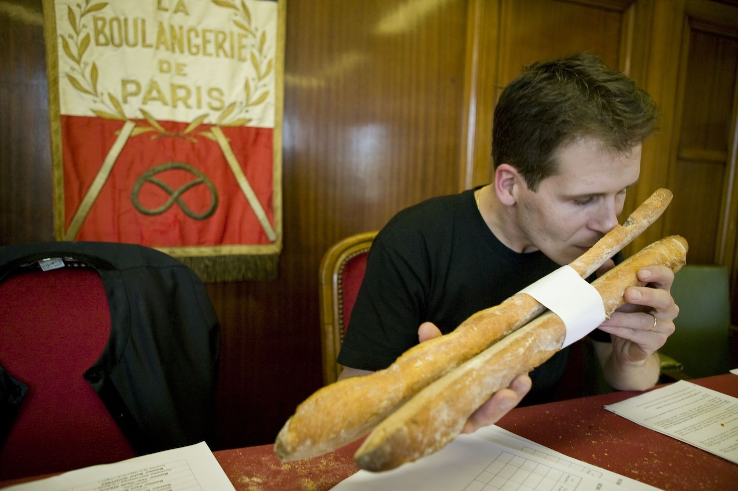 A judge examines the aroma of two baguettes at the 2004 Grand Prix de la Baguette in Paris.